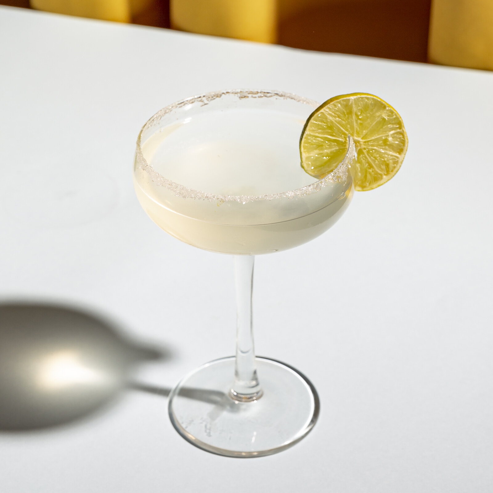 classic-margarita-cocktail-with-salt-edge-saucer-glass-white-table.jpg