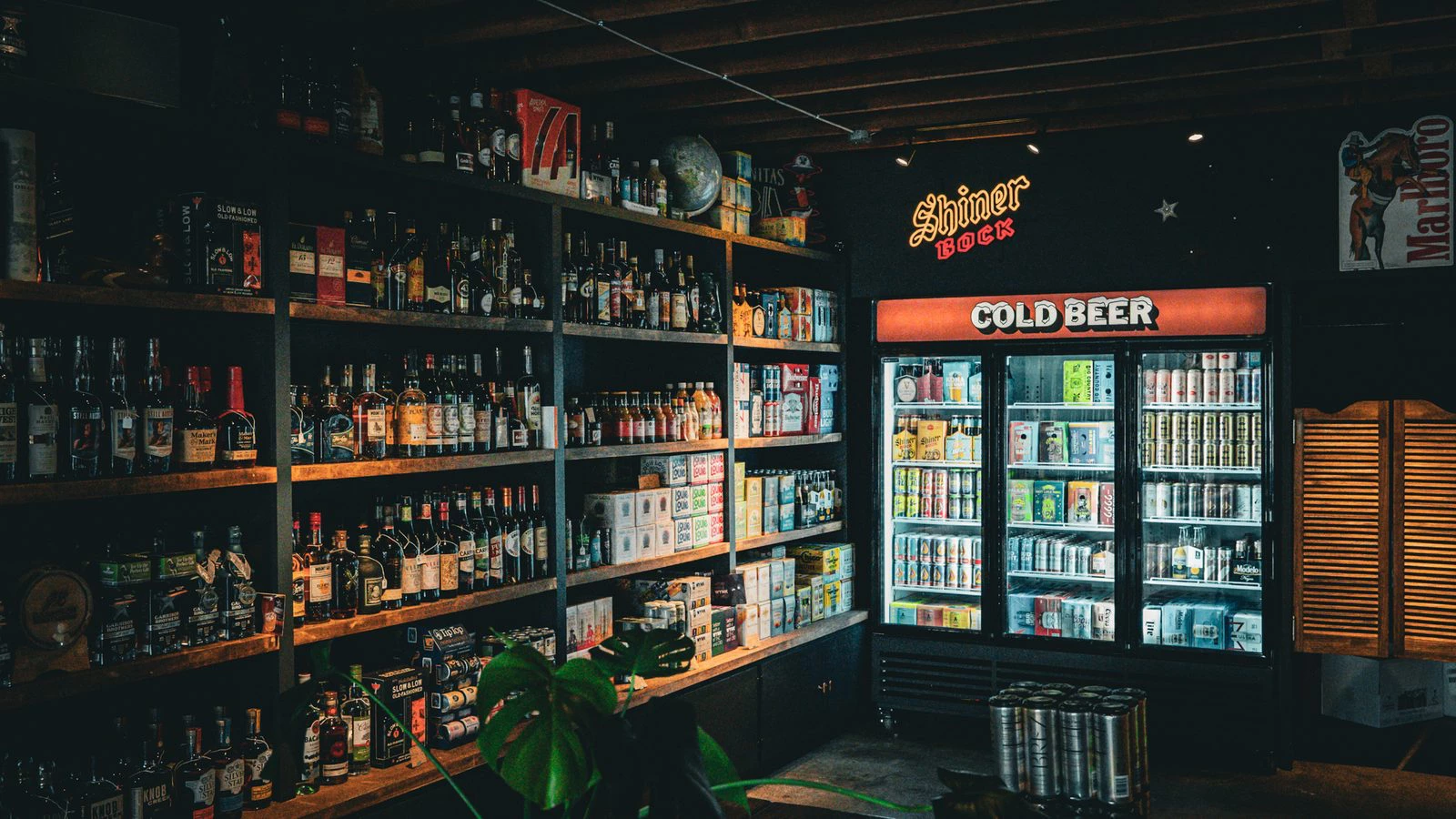 Cold beer cases and the Shiner Bock sign at Goodnight Cowboy on Manor Road